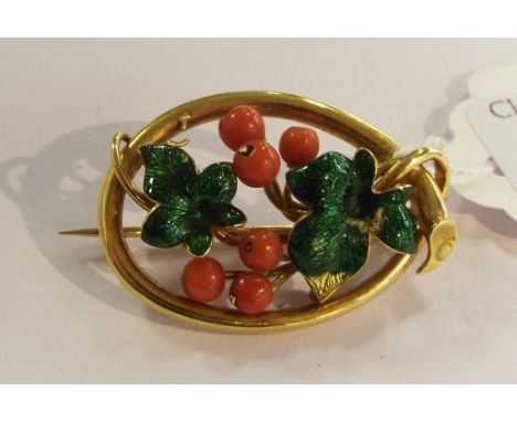 A yellow coloured metal brooch, in the form of grapes and vine leaves, set coral with enamel decoration