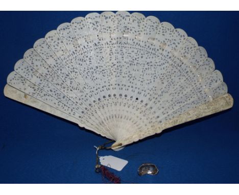 A Chinese silver weight, 2 cm high, and a pierced bone fan (2) Condition report Report by GH

Bone Fan:

Generally good with 