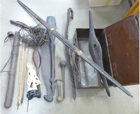 A collection of tribal items; a leather quiver and arrows, two spear throwers, possibly aboriginal, a Congolese dagger, knobk