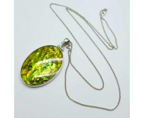 A large mother of pearl pendant with silver chain 