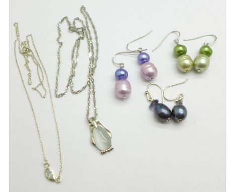 A silver pendant and chain, a chain and a pair of coloured pearl earrings 