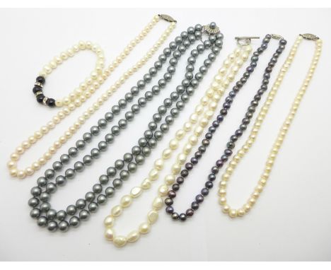Four pearl necklaces including one freshwater with silver fastener, a freshwater pearl bracelet and a double string of faux p