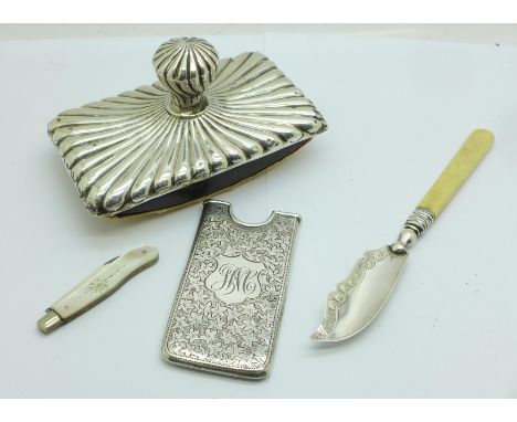 A silver card case, a silver butter knife, a silver and mother of pearl fruit knife and a Victorian silver mounted blotter 