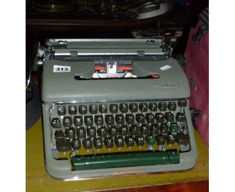 Olympia portable typewriter in metallic green case