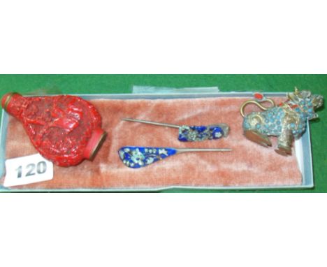 Pair of Oriental enamel hair clips, a carved cinnabar snuff bottle and an ornate brass miniature Fo dog 