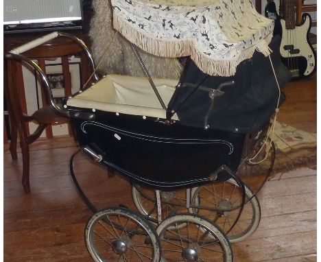 A small vintage "Leeway" coach built pram