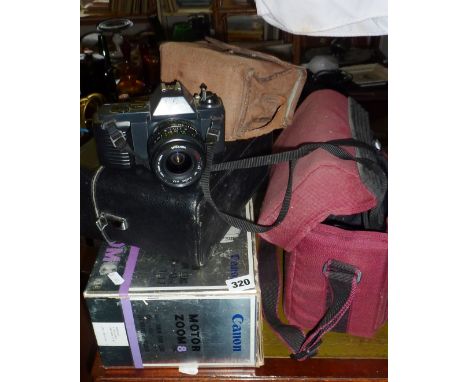 Canon T50 with two lenses, a Canon Motor Zoom 8 movie camera, and a Box Brownie