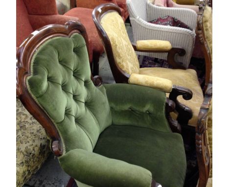 A Victorian button-back armchair upholstered in green material and a similar chair upholstered in gold material