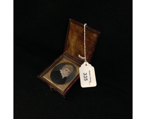 A Regency portrait miniature depicting a young boy in a leather case