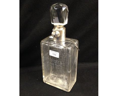 A clear glass decanter with locking silver mounts by Hukin & Heath, hallmarked for Birmingham 1923