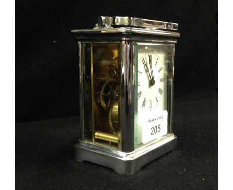 A carriage clock with white enamel dial and silvered frame
