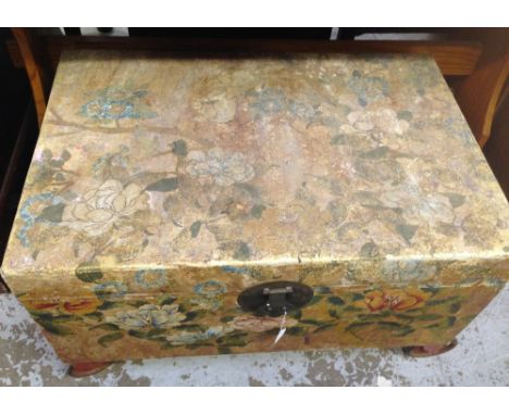 An Oriental paper covered trunk decorated with flowers