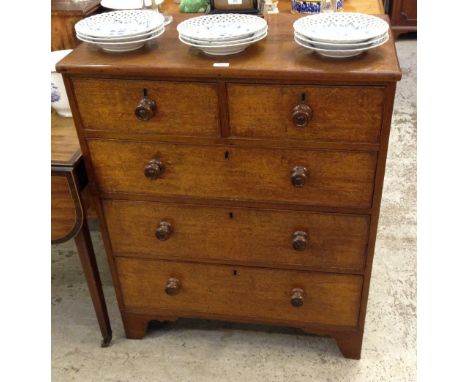 A oak chest with two short and three long graduated drawers with turned knob handles, on bracket feet