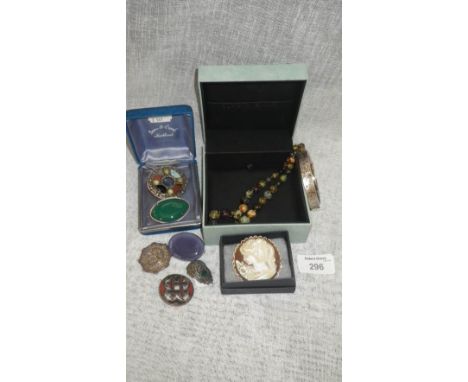 A collection of jewellery including a Ruskin lavender ceramic brooch and a silver bangle