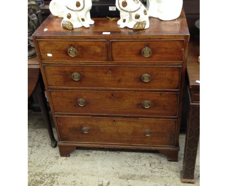A George III mahogany crossbanded chest of two short and three long drawers on bracket feet