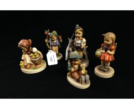 A collection of five Hummel figures of children in various poses
