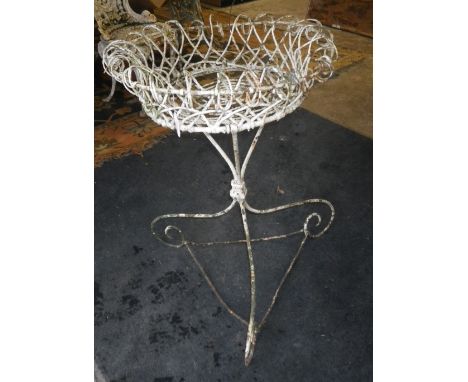 A Victorian style wirework garden planter on scrolling base