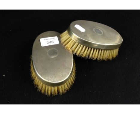 A pair of London silver engine-turned clothes brushes with Whippet and tree crests