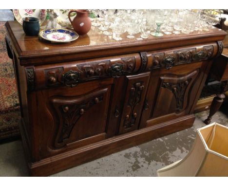 An Edwardian walnut sideboard, with carved Art Nouveau style decoration