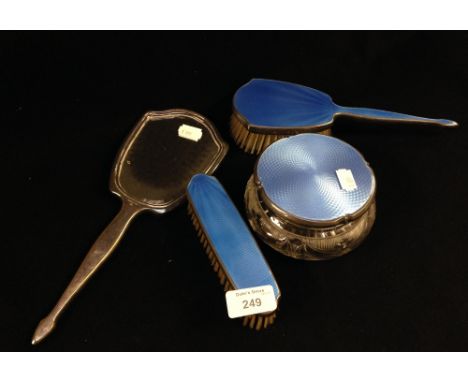 A four piece white metal and blue guilloche enamel dressing table set by Adie Bros.