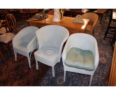 A group of three blue painted woven wicker tub chairs, to include one commode 