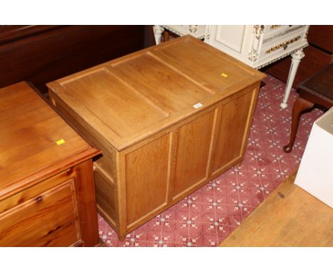 A modern light oak panelled blanket box containing some as new bedding