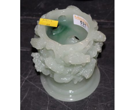 A moulded green glass vase in Chinese jade style.