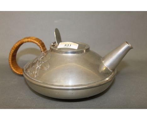 An Archibald Knox for Liberty &amp; Co, Tudric pewter teapot with rattan handle, model No. 0231, 17 cm diameter.
