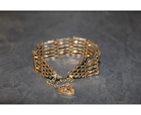 A 9ct gold six bar gate bracelet, with heart shaped padlock clasp and safety chain (some damaged links) 3.7 grams total 