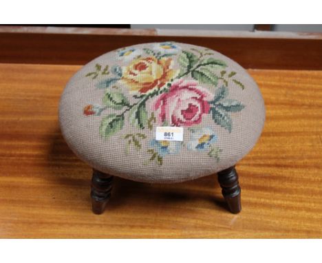 A Victorian mahogany oval footstool, the seat upholstered in floral tapestry. 15 cm high, 29 cm long, 23 cm wide.