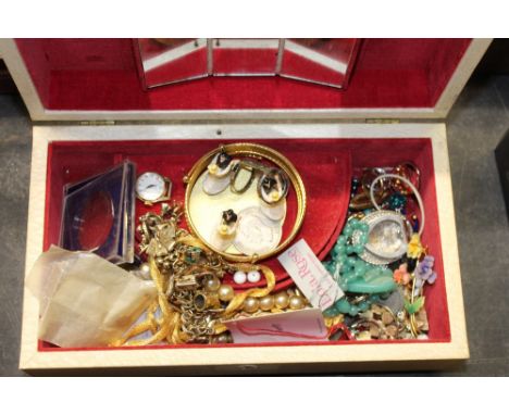 A cream faux leather musical jewellery box, containing a quantity of mixed jewellery and other items including ladies Timex w