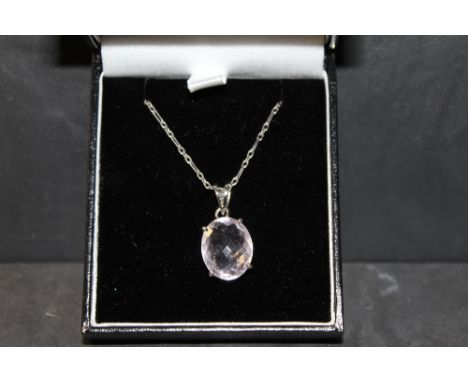 A silver mounted amethyst oval pendant, the faceted pale stone +/- 5 carats in pierced claw setting with chain.