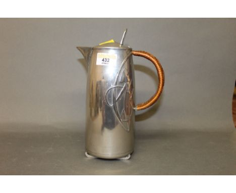 An Archibald Knox for Liberty &amp; Co, Tudric pewter coffeepot with rattan handle, model No. 12131, 23 cm high.