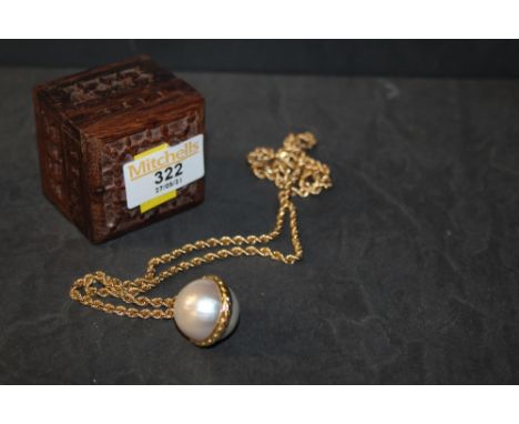 A yellow metal rope twist chain, suspending a four pearl style pendant and housed within a carved hardwood box 