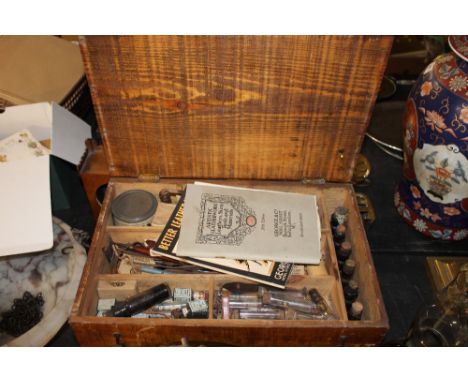 A pine cased set of leather working tools and materials.
