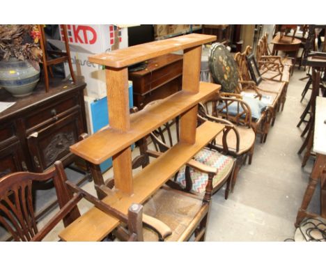 A light oak graduated three tier wall shelf, 77 cm high, 129 cm wide, 15 cm deep