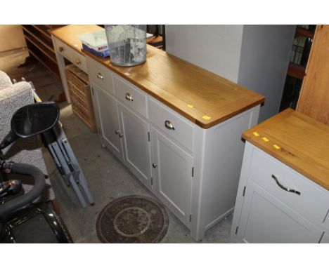 A modern light oak topped and grey painted sideboard, with three drawers and three cupboards, 85 cm x 127 cm x 39.5 cm.