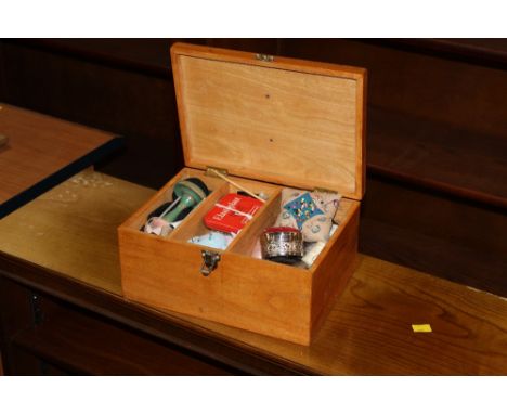 A light oak sewing box, containing various sewing items 