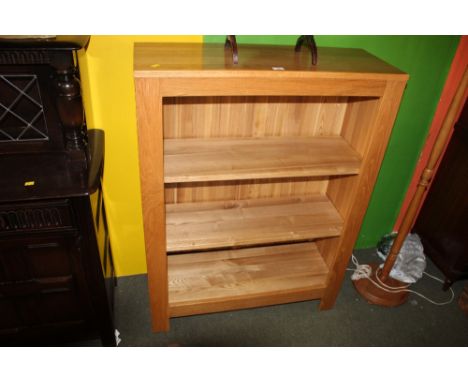 A light oak open front bookcase, fitted three shelves, 121 cm high.