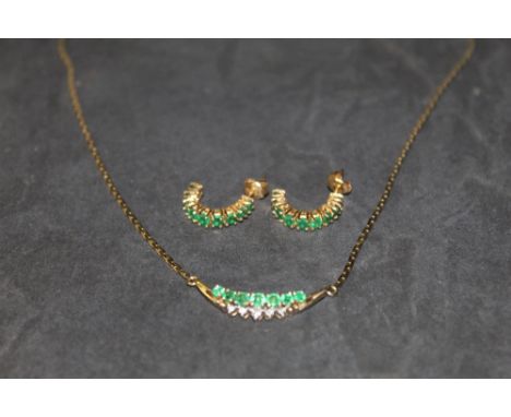 A 14 k gold emerald and diamond crescent pendant necklace, set with seven graduated emeralds and with integral flat link gold