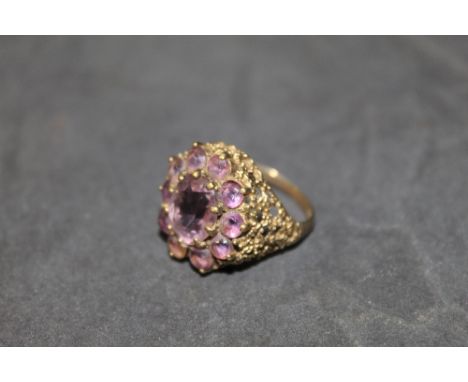 A 9ct gold and amethyst cluster ring, marked 375, ring size R, weight of 7.1 grams 