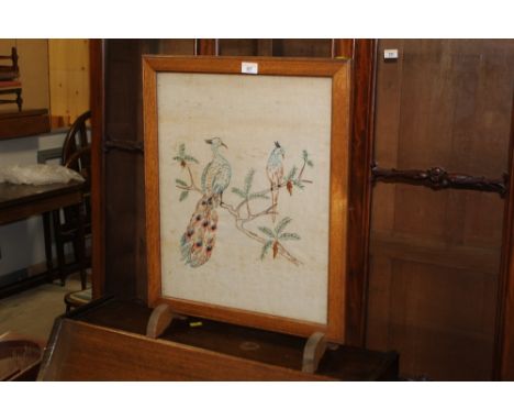 An oak framed fire screen inset with peacock tapestry, 62 cm high