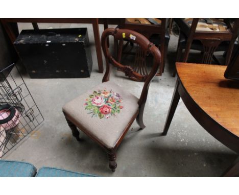 An early Victorian mahogany dining chair with carved crest rail and splat, the drop in seat upholstered in floral tapestry.