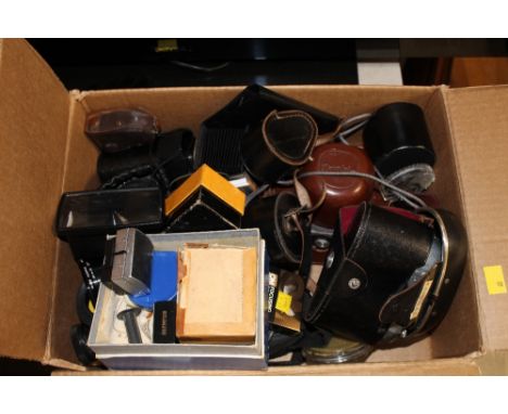 A box of various camera equipment, lenses, camera bodies to include Exakta and also Exa Model 1A, various lens meters etc  