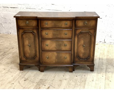 Reprodux, A Regency style mahogany break front side cabinet, the cross banded top over four graduated drawers, flanked by two