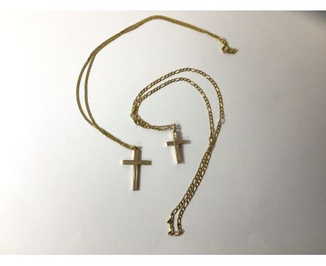 A crucifix marked 375, with engine turned decoration, on trace link chain marked 18ct, a crucifix, markings rubbed, on a chai