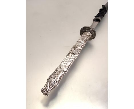 Samuri sword, a 20thc copy, the faux ivory handle in the form of a dragon, silvered metal tsuba with dragon decoration, stain