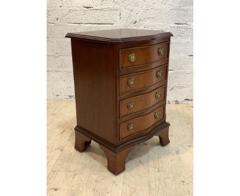 A Georgian style mahogany serpentine chest of small proportions, fitted with four drawers, raised on splayed bracket supports