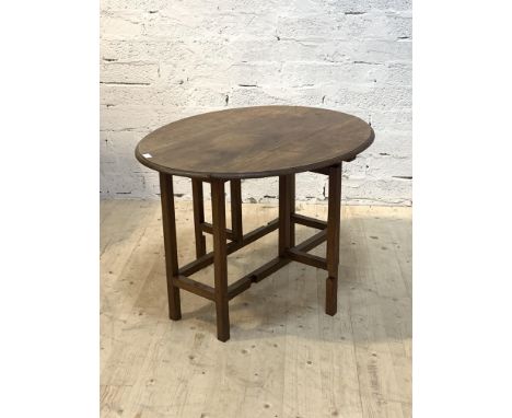 A Cotswold school solid walnut gate leg table, the oval top with unusual reticulated carved edge, raised on square section su