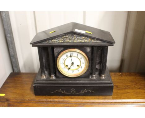 A late Victorian black slate mantel clock of architectural form 